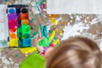 Little girl using watercolour at home during the pandemic lockdown