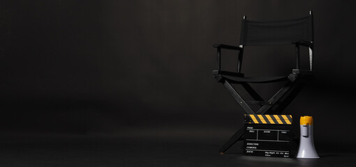 Director chair and Clapper board or movie Clapperboard with yellow megaphone on black background.use in video production or film cinema industryoduction or film cinema industry - obrazy, fototapety, plakaty