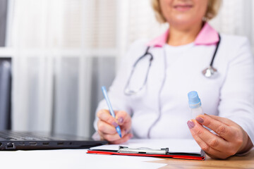 Cropped photo of woman doctor GP or therapist giving recommend drops or drugs to unhealthy patient in clinic. Caring female doctor prescribes medicines to sick client. Medical healthcare