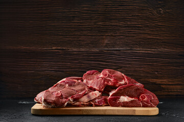 Assortment of raw lamb meat on wooden tray
