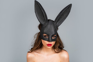Bunny woman. Beautiful naked girl in fashion bunny mask. Egg hunt. Easter rabbit ears.