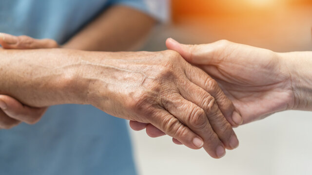 Parkinson disease patient, Alzheimer elderly senior, Arthritis person's hand in support of nursing family caregiver care for disability awareness day, National care givers month, aging society concept