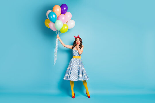 Full length body size view of her she nice attractive lovely amazed worried girlish wavy-haired girl holding air balls flying up isolated on bright vivid shine vibrant blue color background