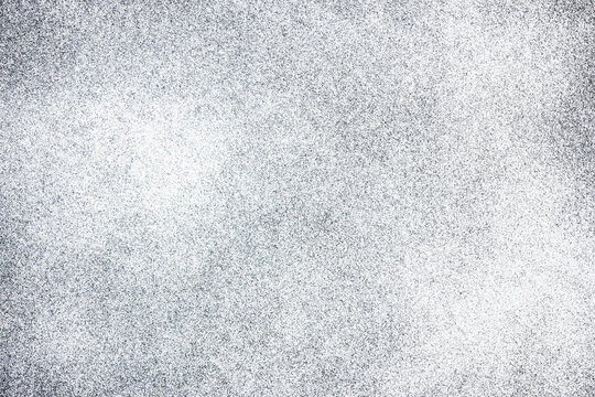 White spray paint on black paper. Noise background. Grain texture overlay. Distressed splatter background.