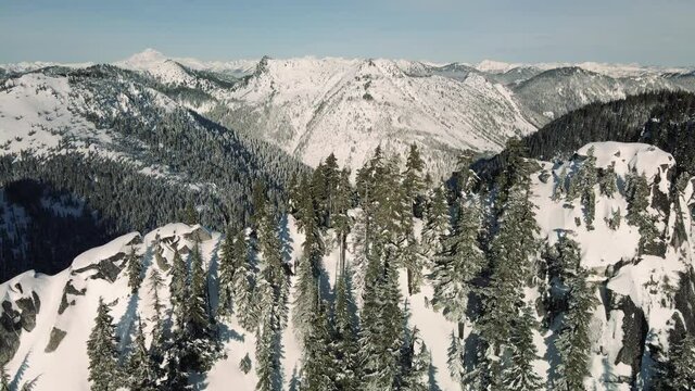 Drone Parallax of Mountain Ridge Foreground with Snowy Cascade Range Background
