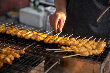 skewers with satay meat are grilled. asian street food