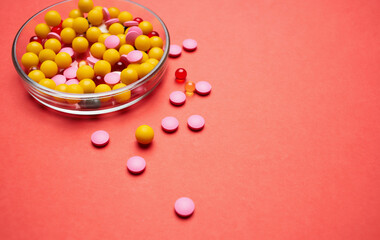 multicolored medicine medicine red background first aid kit