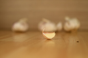 a piece garlic on wooden table in kitchen