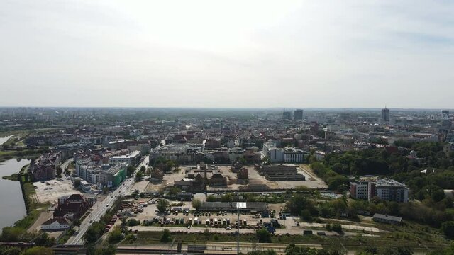 Drone shot of city Poznan, Poland and river Warta in the middle. Beautiful Poznan from a drone. Different kind of buildings in the urban city. Old town in Poland.