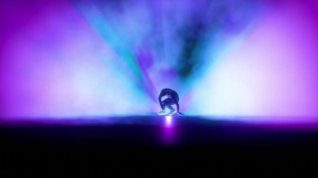 Hip Hop footwork dancer on a stage against colorful spotlights, slow motion, seamless loop, Luma Matte