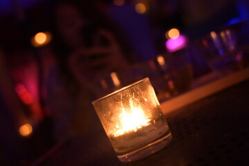 candle in the cup in the night cafe