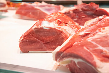 Meat at a butcher's counter.