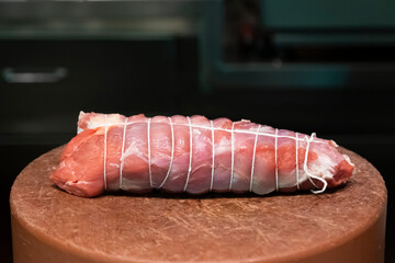 Tied piece of meat for cooking.