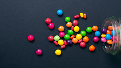 colorful little candies on a colored background