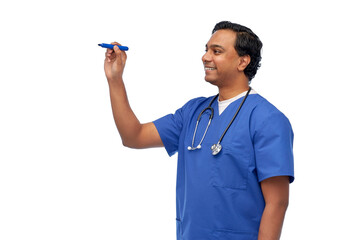 healthcare, profession and medicine concept - happy smiling indian doctor or male nurse in blue uniform writing something with marker over white background