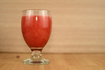 hand holding glass of  water melon juice 