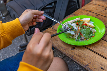 Female traveler eating Vietnamese cuisine - Banh Cuon 