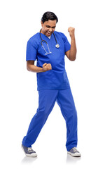healthcare, profession and medicine concept - happy smiling indian doctor or male nurse in blue uniform celebrating success over white background