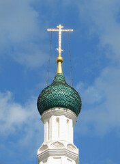 Green dome of an Orthodox church with a gilded cross.     