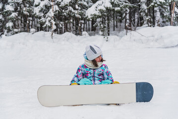 Little girl snowboarder