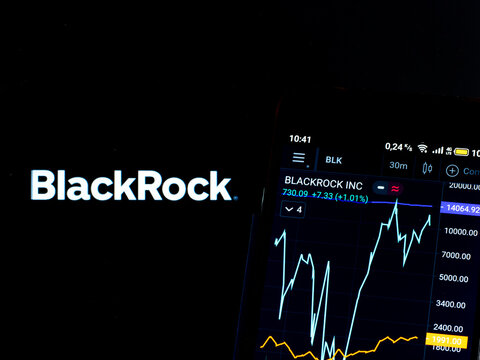 In this photo illustration the stock market information of BlackRock, Inc. displays on a smartphone while the logo of BlackRock, Inc. displays as the background