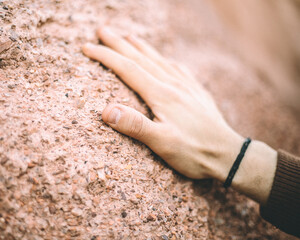 a hand of a young boy clapping the sand