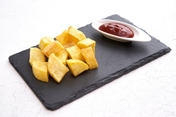 French fries on black slate plate