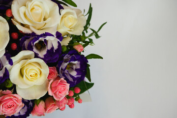 Background. Bouquet of flowers close-up on a white background. White and pink roses, blue-white eustoma. Place for text.