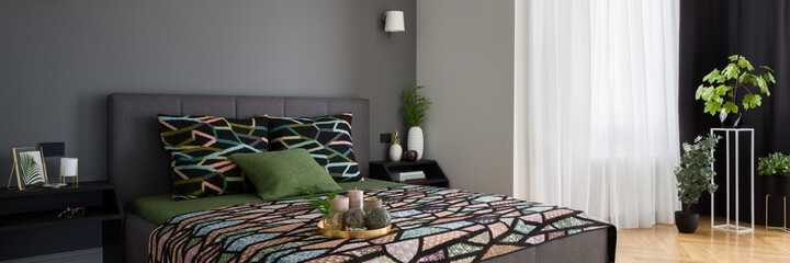 Beautiful bedroom with stylish decorations, panorama