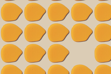 a Photography of one drop of honey with its shadow from the afternoon sun on the table has been multiplied and arranged in a graphic style.