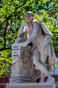 William Shakespeare marble statue erected in 1874 in Leicester Square Gardens London England UK which is a popular tourist travel destination attraction landmark, stock photo image