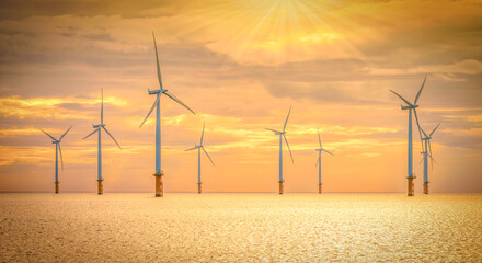 Offshore Wind Turbine in a Windfarm under construction off the England Coast at sunset