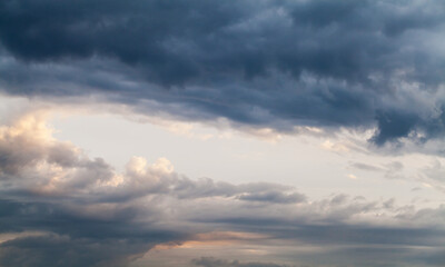 Naklejka na ściany i meble Dark cloudy tropical sky at sunset, natural background