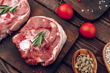 Raw meat beef shank slices on brown wooden board