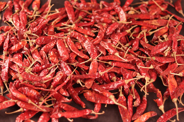 Fototapeta premium pile of dried red chili pepper as a food background with Chili pepper powder in bowl,smoked red paprika spicy with Chili powder,crushed red chili pepper with dry Red chili