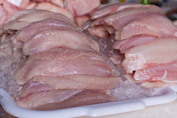 Fresh Guaiivira fish fillet preserved in ice at the fish market. Ocean fish consumed throughout the...