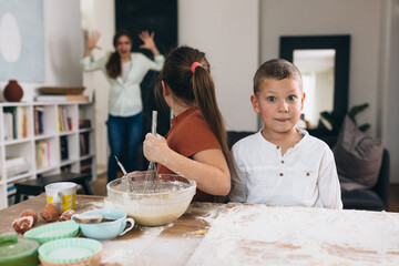 kids baking at home. they are making a big mess