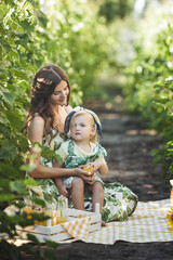 Young mother and her little daughter outdoors having fun. Pretty family. Girls leisure