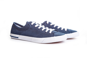 blue sneakers on white background with copy space. Youth shoes.