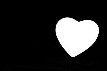 Big image of a heart shaped, white heart on a black background. Black and white picture. Light shape. Series of symbolic images. Sign of love. Love symbol. 
