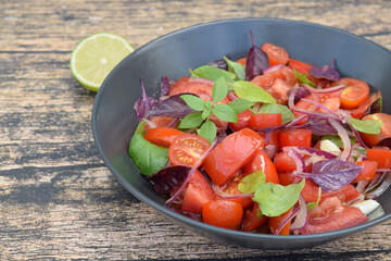 Tomato basil salad with purple basil, lime juice and red onion