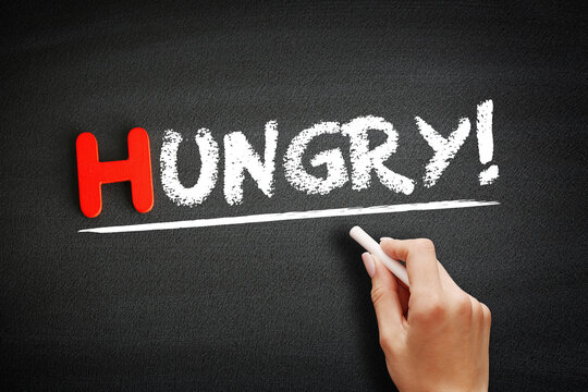Hungry! text on blackboard, food concept background