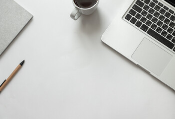 Freelancer desk with macbook on white background near notepad and pen