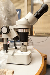 laboratory microscope with rock mineral sample