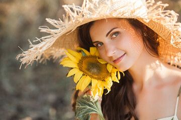 Attractive young blond woman with bouquet of sunflowers. Allergy free concept. Female with flowers...