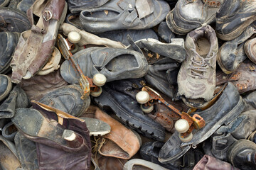 A lot of old trash shoes with pair of rusty roller skates