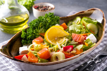 Salmon salad with fresh vegetables and cheese. Diet and healthy food