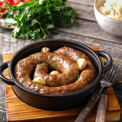 Homemade fried sausages on a pan.