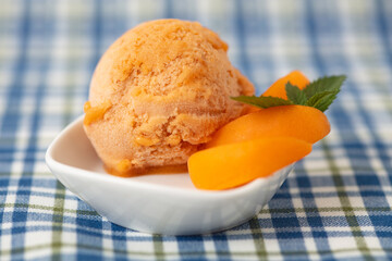 Fresh scoop of apricot ice cream with apricots