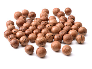 Shelled and unshelled macadamia nuts on white background